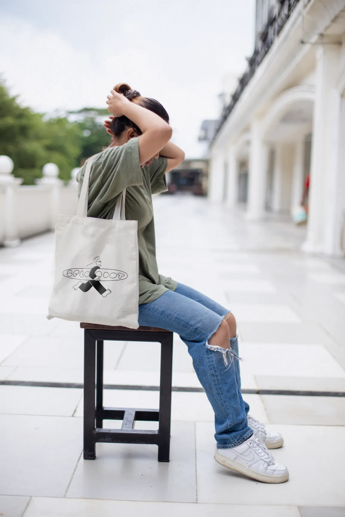 Ecobag Sploot no ombro de uma pessoa sentada